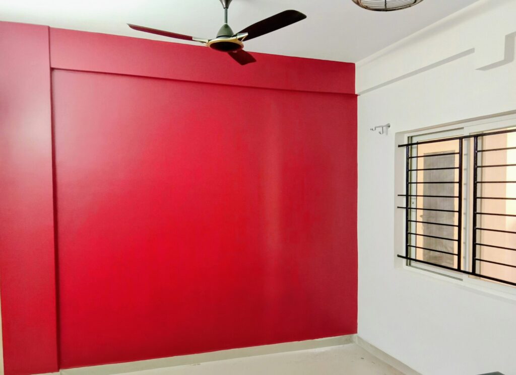 Professional painters from Ajay Home Painting And Interior Decor Services working on interior wall painting with clean and precise finishing